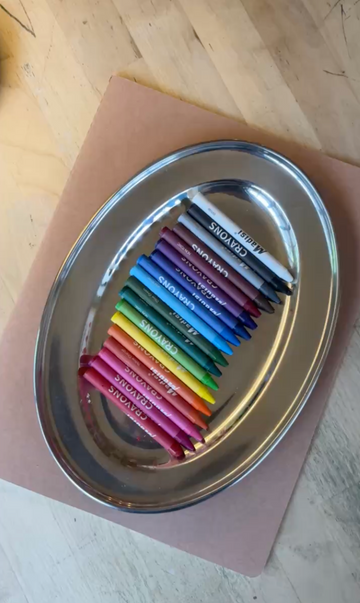 Rainbow crayons arranged on a tray at Art Café SLC creative studio in Salt Lake City